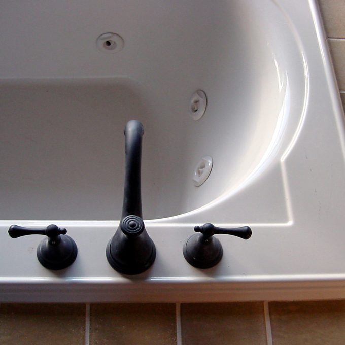 top view of white jacuzzi bathtub with black faucet